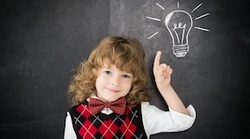 Girl pointing to a chalkboard lightbulb
